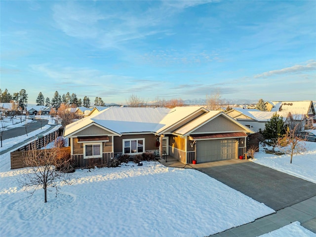 ranch-style home featuring a garage, a residential view, and driveway