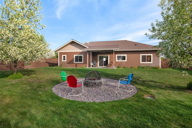 115 Stryker Peak Trl, Kalispell, MT 59901 - back of property with an outdoor fire pit and a patio