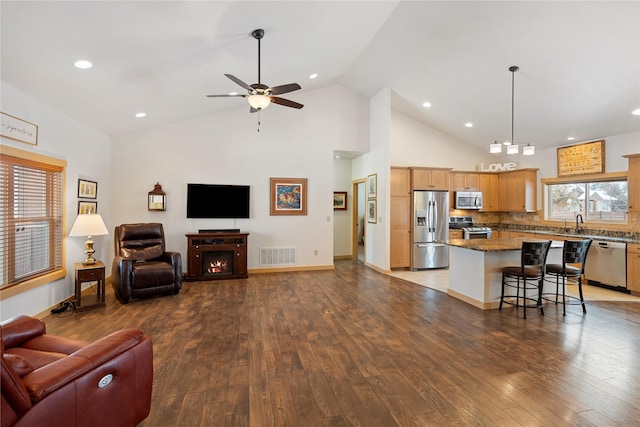 115 Stryker Peak Trl, Kalispell, MT 59901 - living area featuring ceiling fan, hardwood / wood-style flooring, high vaulted ceiling, recessed lighting, and baseboards