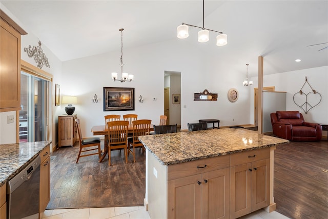 115 Stryker Peak Trl, Kalispell, MT 59901 - kitchen featuring stainless steel dishwasher, a chandelier, dark wood-style floors, stone counters, and high vaulted ceiling
