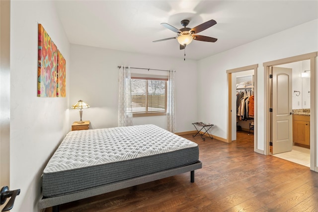 115 Stryker Peak Trl, Kalispell, MT 59901 - bedroom with a walk in closet, light wood-style flooring, baseboards, a closet, and ceiling fan