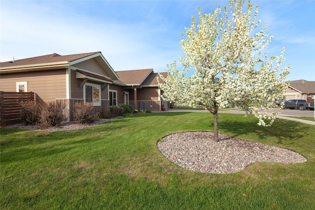 115 Stryker Peak Trl, Kalispell, MT 59901 - view of side of home with a lawn and a shingled roof