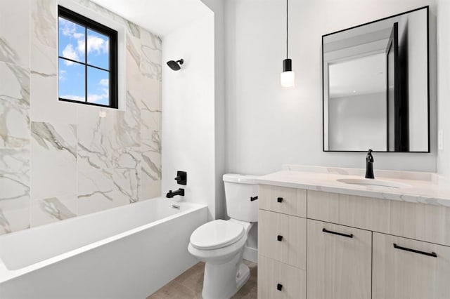 full bathroom featuring tiled shower / bath combo, vanity, and toilet