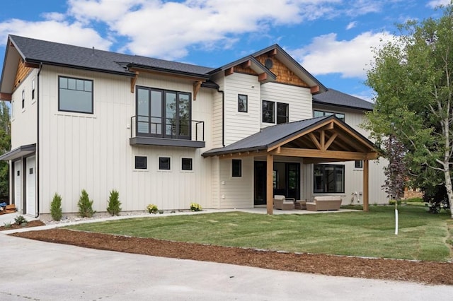 view of front of property with a patio, a balcony, an outdoor hangout area, and a front lawn