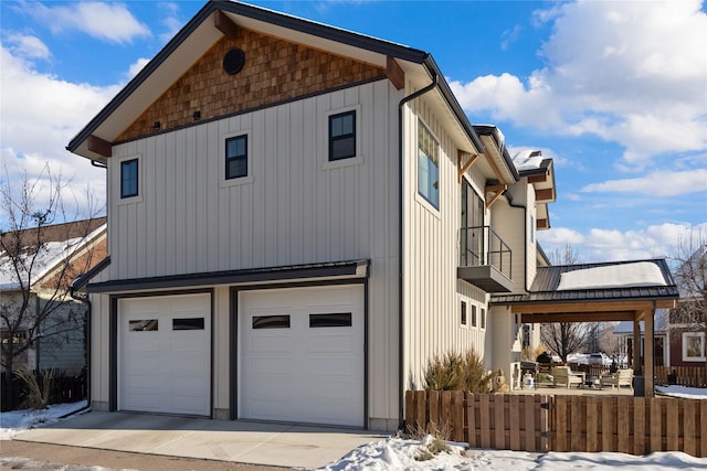 view of snow covered exterior featuring a garage