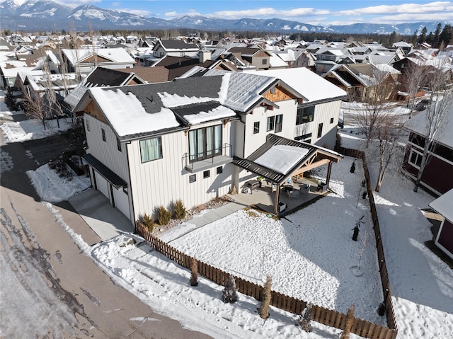 snowy aerial view featuring a mountain view