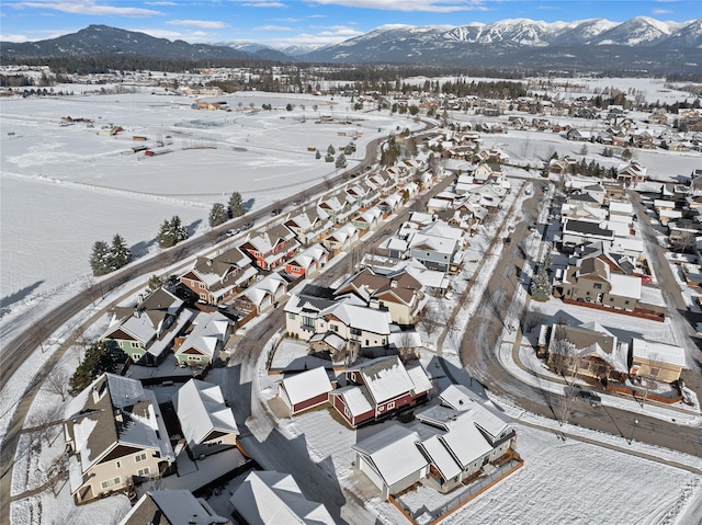 snowy aerial view with a mountain view