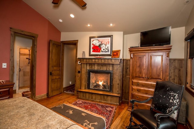 living area with hardwood / wood-style flooring, vaulted ceiling, and ceiling fan