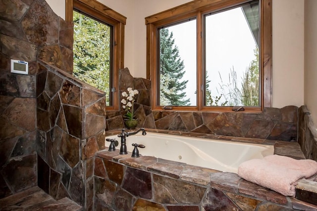 bathroom with a relaxing tiled tub