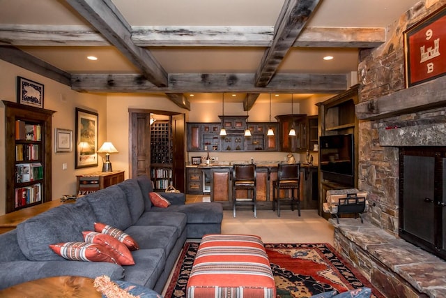 living room with a stone fireplace, coffered ceiling, and beam ceiling