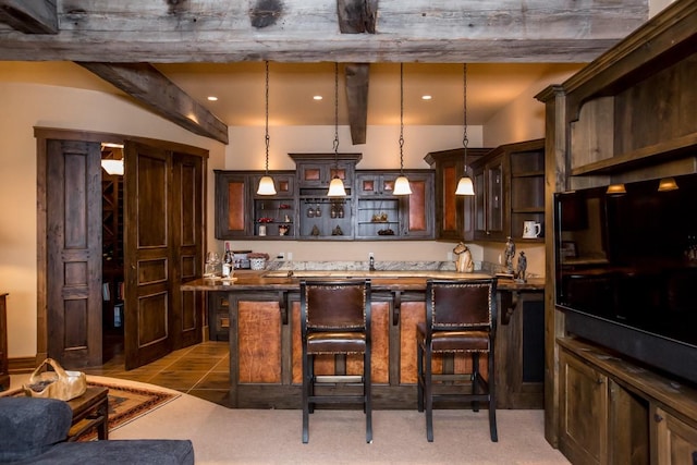 bar featuring tile patterned flooring, dark brown cabinets, pendant lighting, and beam ceiling