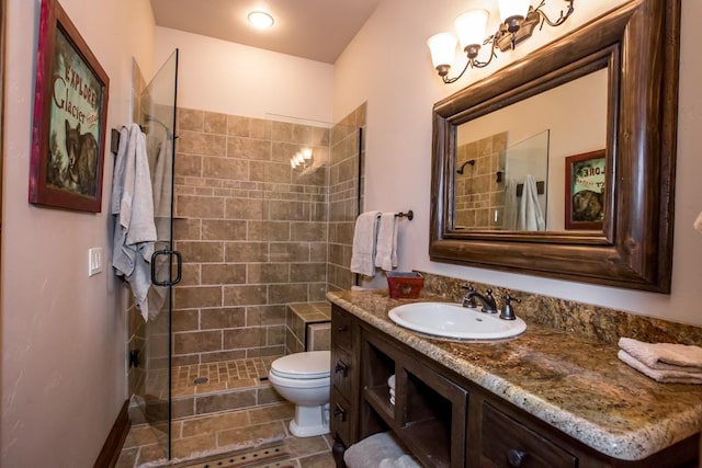 bathroom featuring vanity, an enclosed shower, and toilet