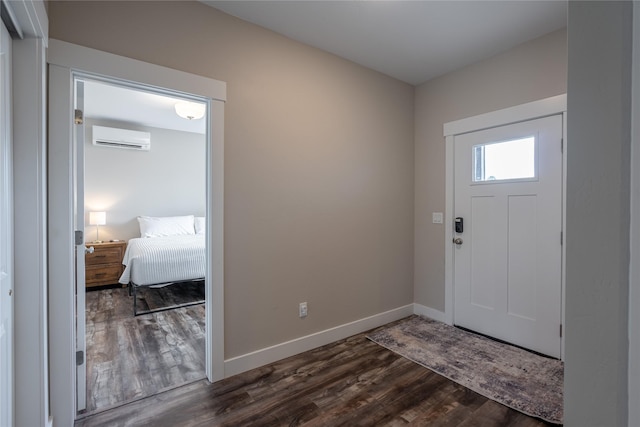 foyer with dark wood-type flooring and a wall unit AC