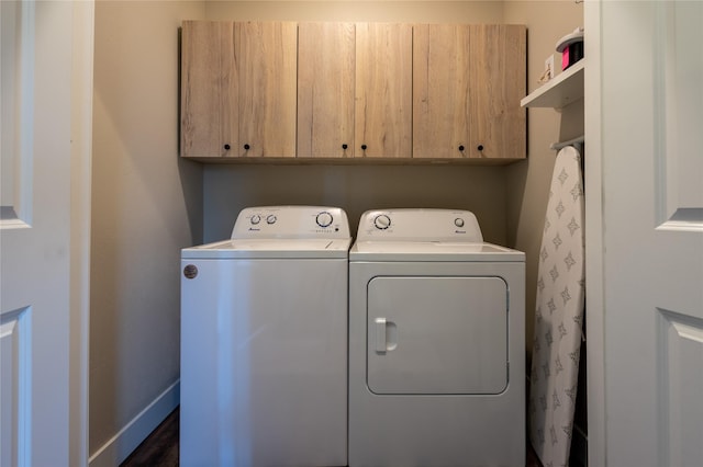 laundry area featuring washing machine and dryer and cabinets