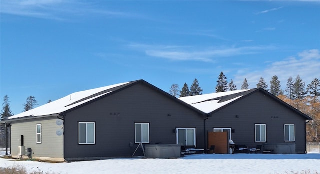 view of snow covered rear of property