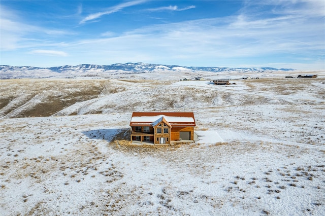 snowy aerial view featuring a mountain view