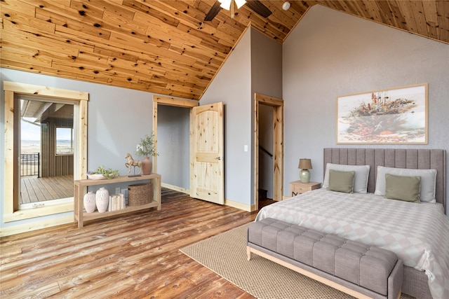 bedroom with baseboards, high vaulted ceiling, wood finished floors, and wooden ceiling