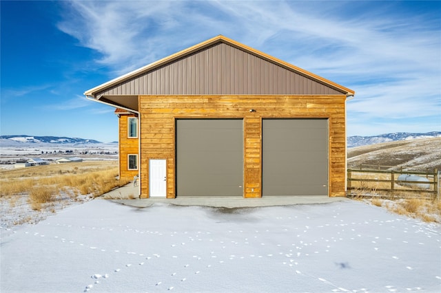 snow covered garage with a mountain view