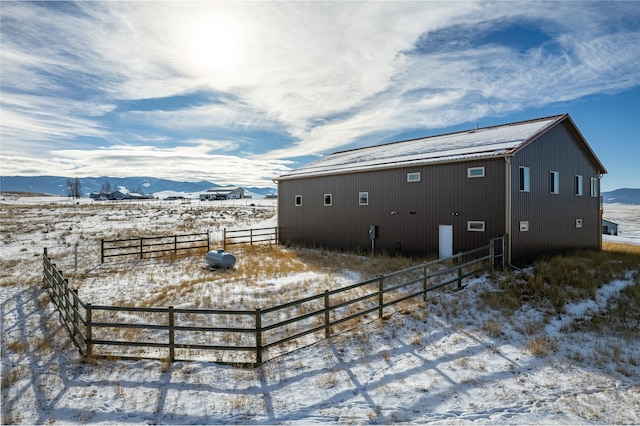 view of snow covered exterior featuring a mountain view