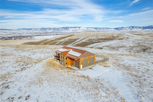 snowy aerial view featuring a mountain view