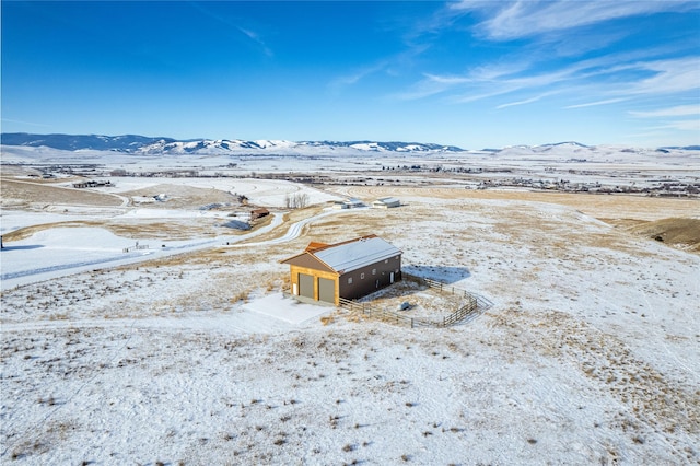 snowy aerial view with a mountain view