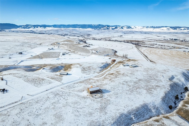 snowy aerial view featuring a mountain view