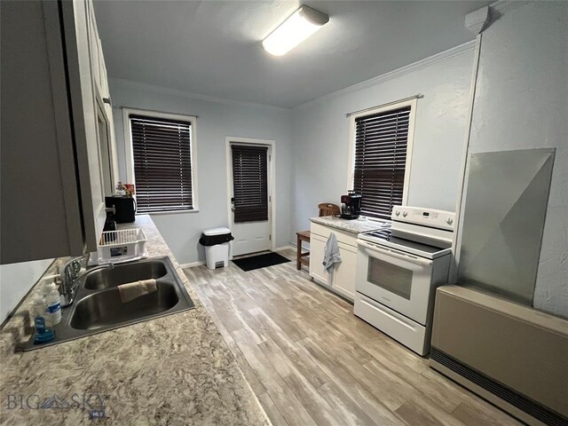 303 W Park St, Butte, MT 59701 - kitchen featuring white cabinetry, light hardwood / wood-style floors, white electric range oven, crown molding, and sink