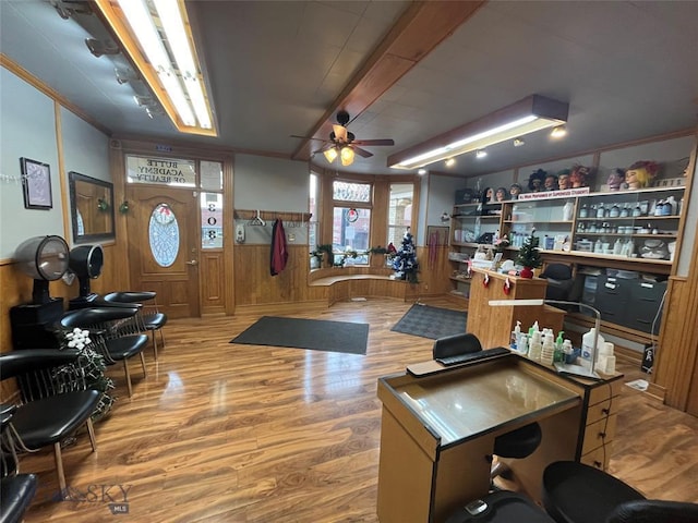 office area featuring ceiling fan, wooden walls, and hardwood / wood-style flooring