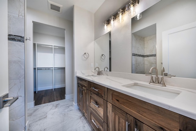 bathroom with a shower and vanity