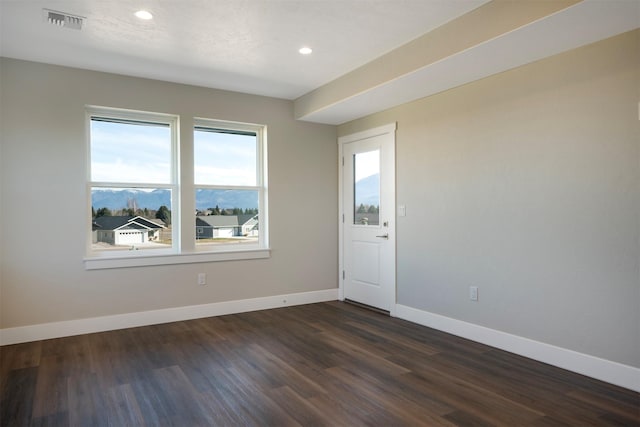 empty room with dark wood-type flooring