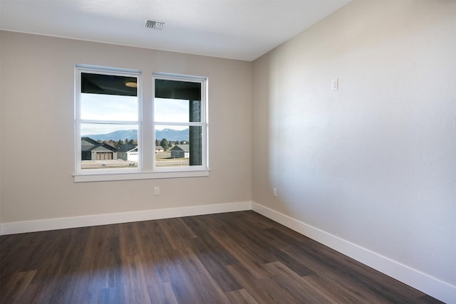 empty room featuring dark wood-type flooring