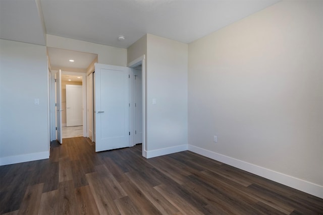 unfurnished bedroom with dark hardwood / wood-style flooring