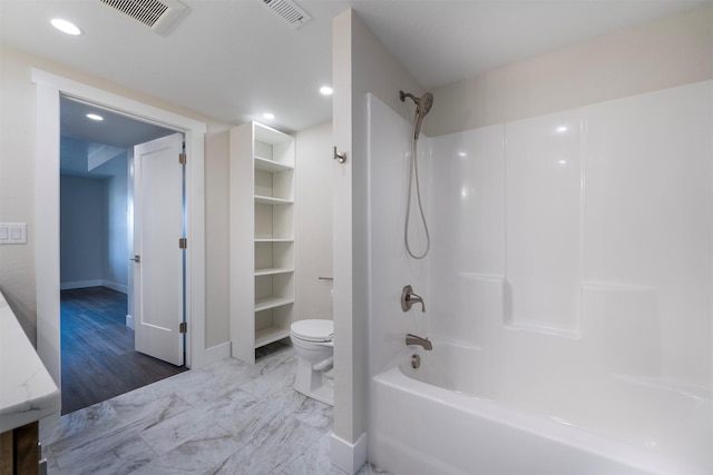 bathroom with toilet and bathing tub / shower combination