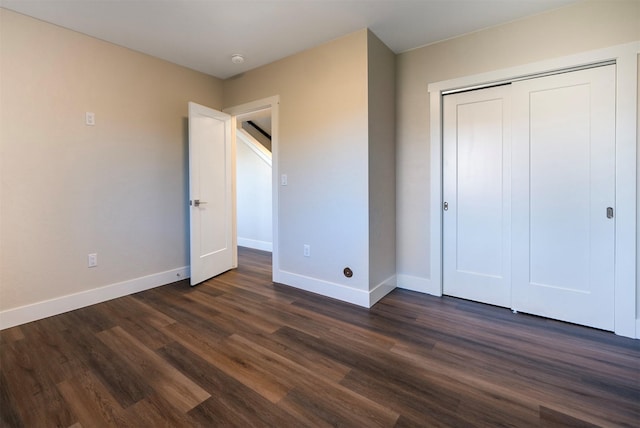 unfurnished bedroom featuring dark hardwood / wood-style floors and a closet