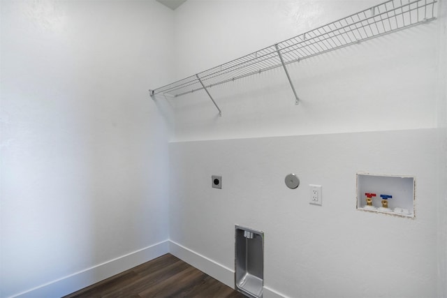 clothes washing area with dark wood-type flooring, hookup for a washing machine, and hookup for an electric dryer