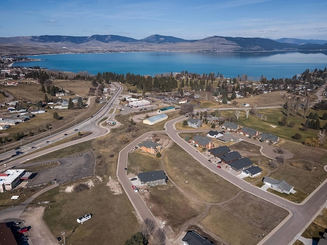 drone / aerial view featuring a water and mountain view