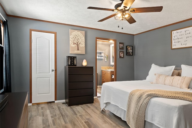 bedroom with a textured ceiling, ceiling fan, connected bathroom, and light hardwood / wood-style flooring