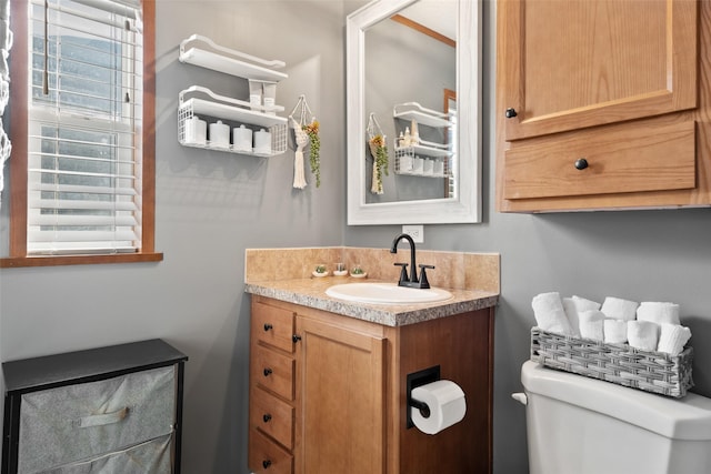 bathroom featuring toilet and vanity