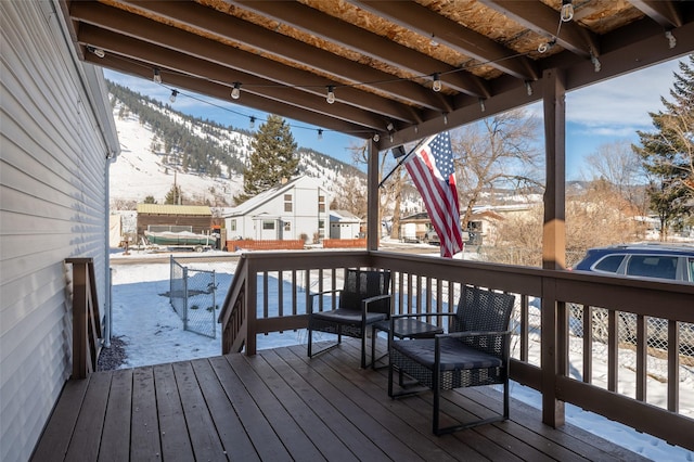 snow covered deck featuring a mountain view