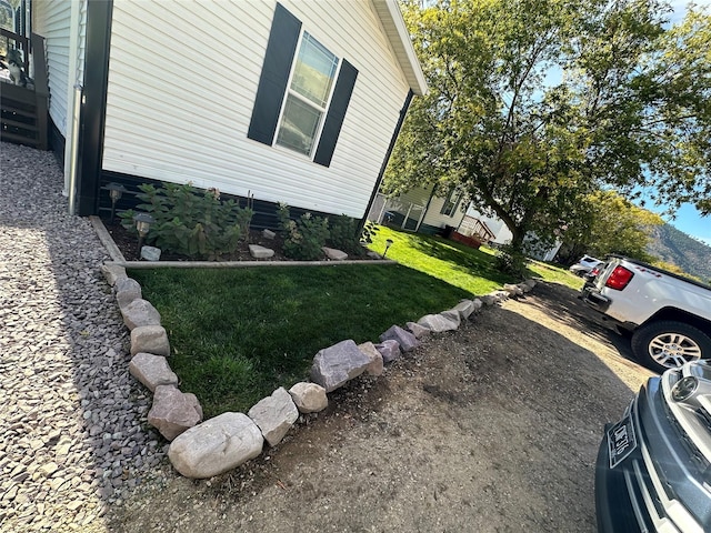 view of property exterior featuring a lawn