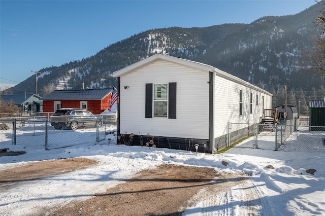 view of snowy exterior with a mountain view