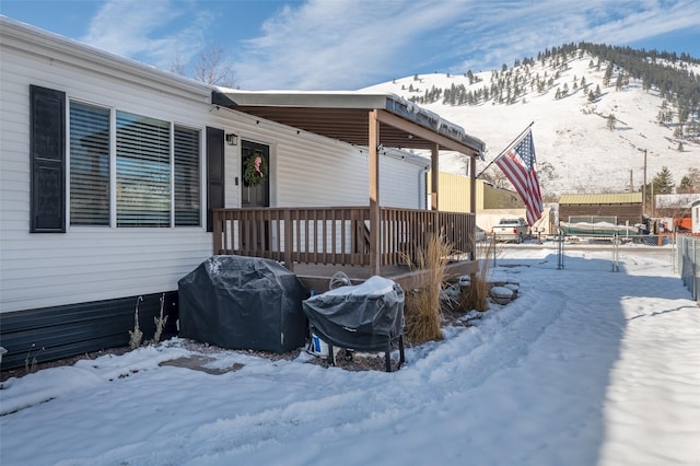 snow covered deck featuring grilling area