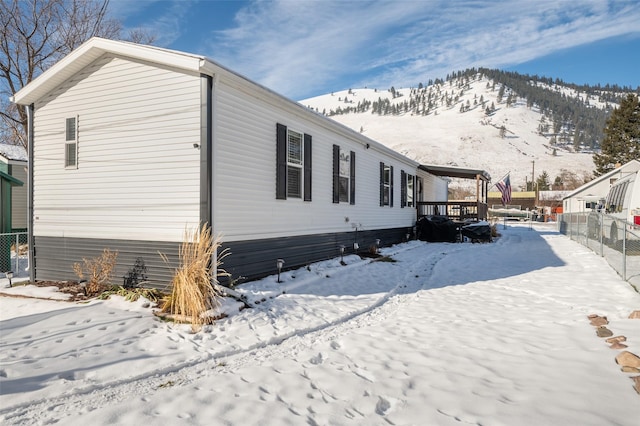 view of snowy exterior with a mountain view