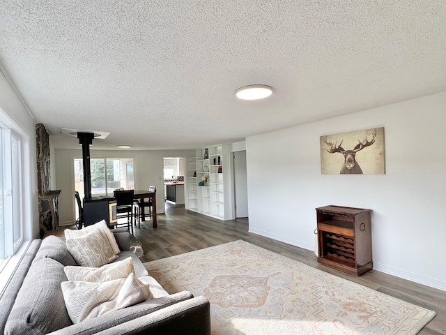 living area featuring wood finished floors and a textured ceiling