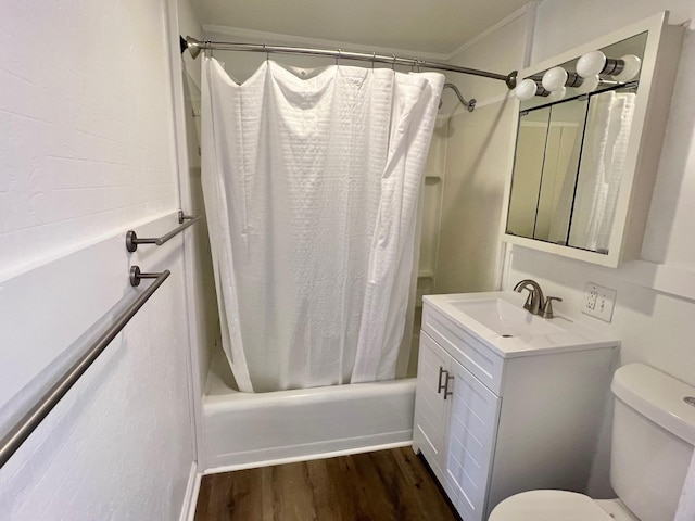 bathroom with vanity, toilet, wood finished floors, and shower / bath combo