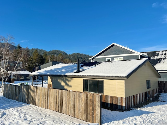 view of snowy exterior featuring fence