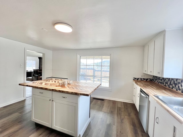 kitchen with visible vents, stainless steel dishwasher, dark wood finished floors, white cabinets, and butcher block counters