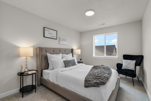 carpeted bedroom featuring a textured ceiling