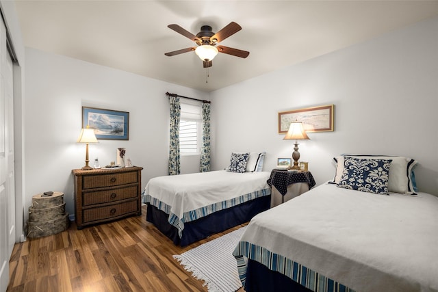 bedroom with ceiling fan, a closet, and dark hardwood / wood-style flooring