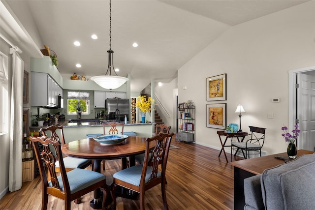 dining room featuring hardwood / wood-style flooring and lofted ceiling